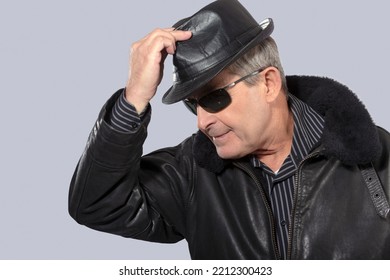 Handsome Elderly Man With Sunglasses, Hat And Black Leather Jacket