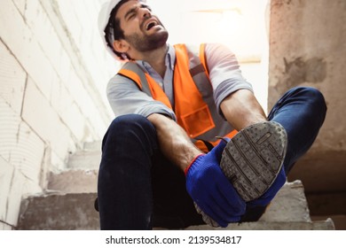 Handsome Engineer Injured His Ankle When He Stepped On A Nail While Inspecting A House Project. Concept Of Occupational Safety And Occupational Accident Insurance.