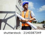 Handsome engineer man and architect working at construction site with calculate spending report inside house. Real Estate Project with Civil Engineer