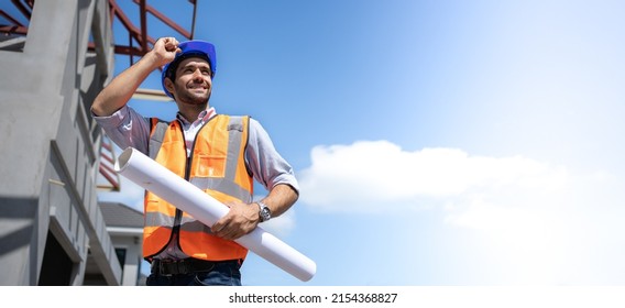 Handsome engineer smiling confidently at the project site under construction.Middle Eastern American workers wearing hard hats and reflective vests holding blueprint.Safety first concept,ppe wearing. - Powered by Shutterstock