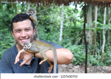 Handsome Ethnic Man With Titi Monkeys Handsome Ethnic Man With Titi Monkeys