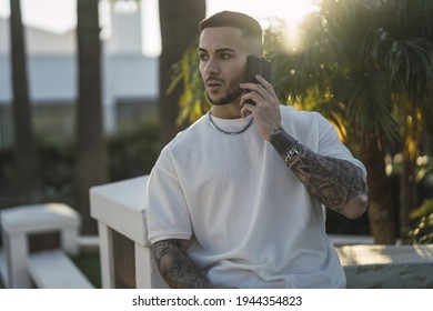 A Handsome European Man Talking On The Phone With A Surprised Face Expression