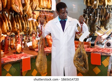 Handsome Experienced Butcher Shop Owner Checking Quality Of Jamon Before Sale