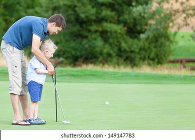 handsome father and his cute son playing golf together