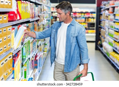 Handsome Father Picking Box Of Cereals At Supermarket