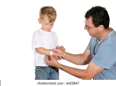 Handsome Father Putting A Band Aid On His Son’s Arm