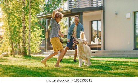 Handsome Father, and Son Play Catch With Loyal Family Friend Golden Retriever Dog. Family Spending Time Together Training Dog. Sunny Day Idyllic Suburban Home Backyard. - Shutterstock ID 1853535811