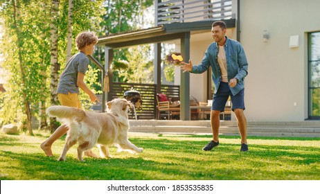 Handsome Father and Son Spend Quality Family Time Together, Play Soccer with Football, Passing to Each other, and Having Fun. Sunny Day Idyllic Suburban Home Backyard with Loyal Golden Retriever Dog - Shutterstock ID 1853535835
