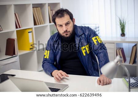 Handsome FBI agent sitting in his office