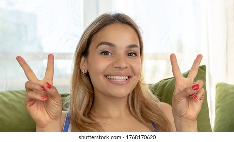 Handsome Female Making Funny Faces On Her Couch At Home. Being Silly And Playful Like A Child. 