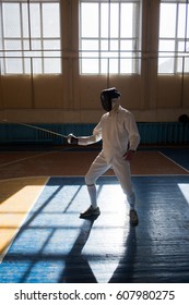 Handsome fencer prepares for competitions and a training. Fencer stand with sword and mask. Fencer with sword. Sword. Men with sword. Fencing. Training. Motivation. Sport. Sport man, Young man