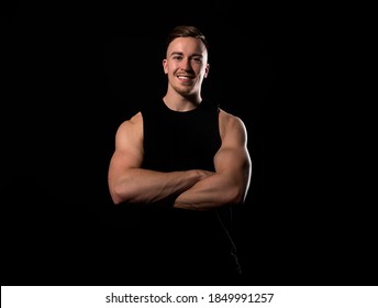 Handsome And Fit Bodybuilder Posing On Black Background In Workout Gear