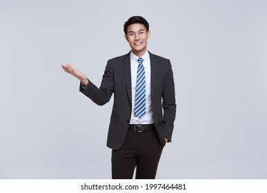 Handsome And Friendly Face Asian Businessman Smile In Formal Suit On White Background Studio Shot.