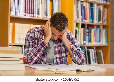 Handsome Frustrated Student Studying His Books In Library