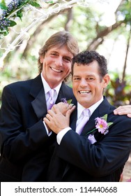 Handsome Gay Couple Pose For Portrait On Their Wedding Day.