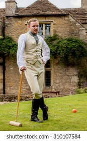 Handsome Ginger Hair Man Dressed In Regency Period Costume Playing Croquet. Image With Selective Focus