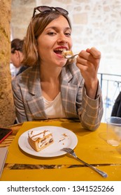 Handsome Girl In Sicily Eating The Original Cassata Siciliana, Baked Ricotta Cake With Chocolate Chips And Coffee Beans