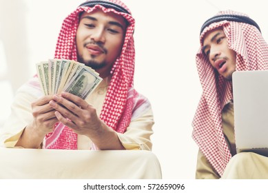 Handsome Greedy Arab Man Showing Money On Hands And Counting Money. Financial Corruption Concept.