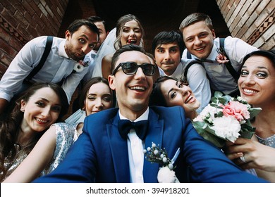 Handsome groom selfie with fun beautiful bridesmaids & groomsmen - Powered by Shutterstock