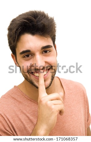 Handsome guy with beard commanding silence on white background