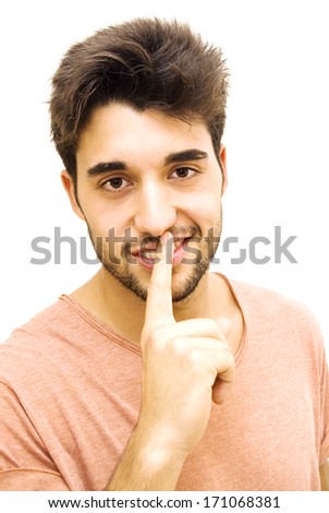 Handsome guy with beard commanding silence on white background