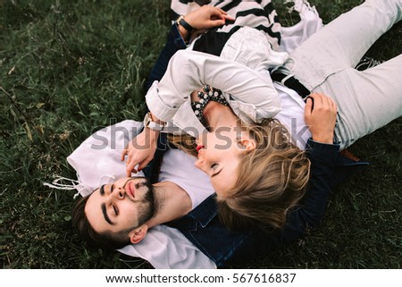 Similar – Women friends with sunglasses looking each other lying