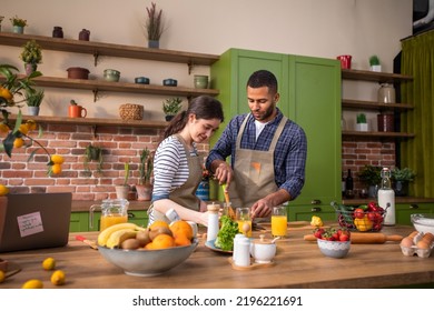 Handsome Guy And Caucasian Lady Together In The Morning Take The Breakfast Together At The Kitchen Island At Home They Drink Some Fresh Orange Juice