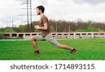 Handsome guy doing physical exercises in the stadium.
