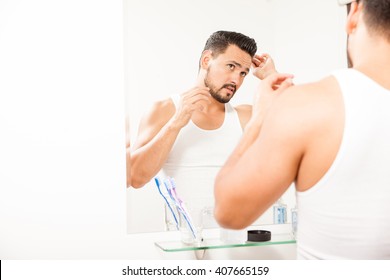 Handsome Guy Getting Ready For Work And Combing His Hair In Front Of A Mirror In A Bathroom