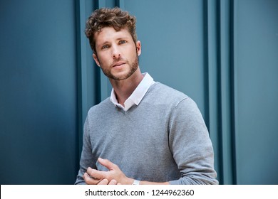 Handsome guy in grey looking to camera