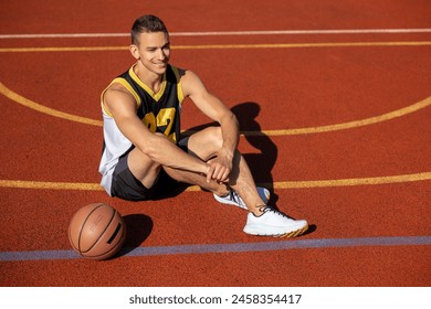 Handsome guy having basketball workout on outdoor summer playground - Powered by Shutterstock