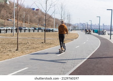 Handsome Guy Man Riding On Electric Urban Modern Scooter. Eco Transport, Technology Concept