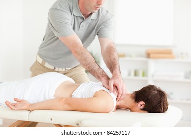 Handsome Guy massaging a cute woman's neck in a room - Powered by Shutterstock