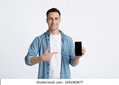 Handsome Guy Pointing Finger At Empty Screen Phone, On White Background