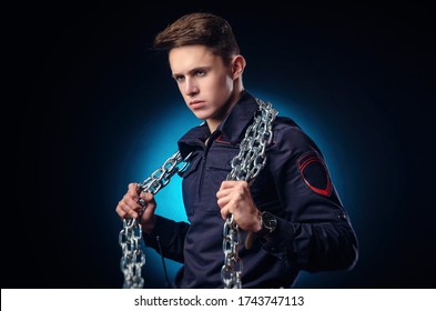 A Handsome Guy In A Police Uniform With A Big Chain On His Shoulder. Prison Warden