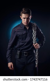 A Handsome Guy In A Police Uniform With A Big Chain On His Shoulder. Prison Warden