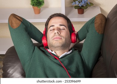 Handsome guy relaxed and using technology on sofa