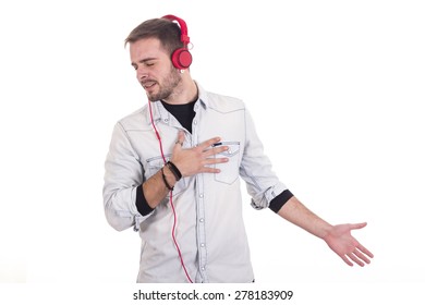 Handsome guy singing music using red headphones