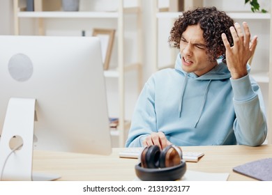 Handsome Guy Sitting At A Table In Front Of A Computer Freelance Technologies