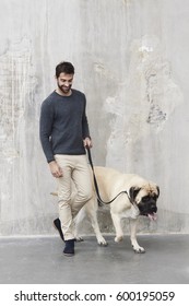 Handsome Guy Walking Dog In Studio