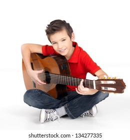 Handsome happy  boy is playing on acoustic guitar - isolated on white background