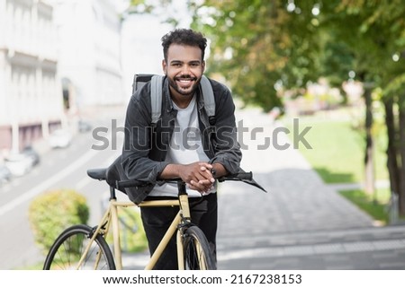 Handsome happy young man with bicycle on a city street, Active lifestyle, people concept