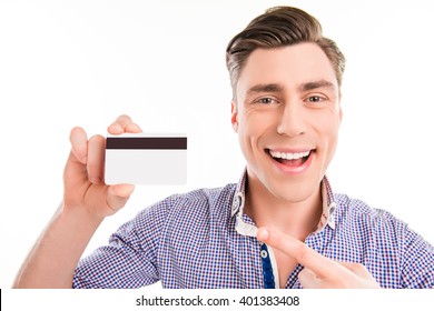 Handsome happy young man pointing on bank card