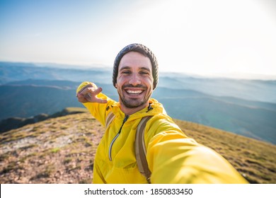 Handsome Hiker Taking A Selfie On The Top Of The Mountain - Happy Man With Backpack Smiling At The Camera - Bright Filter