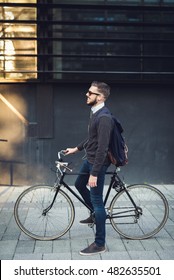 Handsome hipster cycling through the city. - Shutterstock ID 482635501
