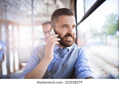 Handsome hipster modern man calling by mobile phone in tram