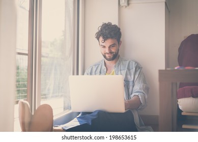 handsome hipster modern man designer working home using laptop at home - Shutterstock ID 198653615