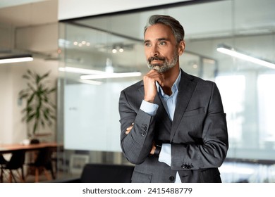 Handsome hispanic concentrated senior business man thinking, looking aside. European latin confident mature good looking middle age leader male businessman on office blur background with copy space. - Powered by Shutterstock