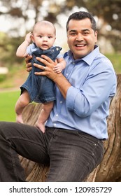 Handsome Hispanic Father And Son Posing For A Portrait In The Park.