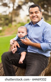 Handsome Hispanic Father And Son Posing For A Portrait In The Park.